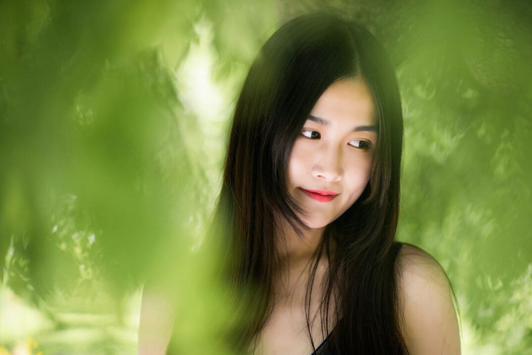Portrait of a young woman with dark hair smiling